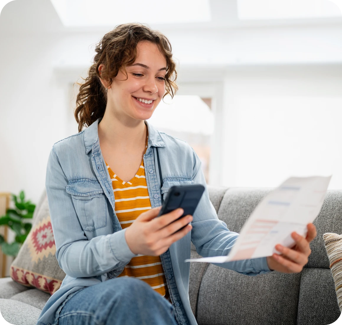 Happy woman checking phone and document